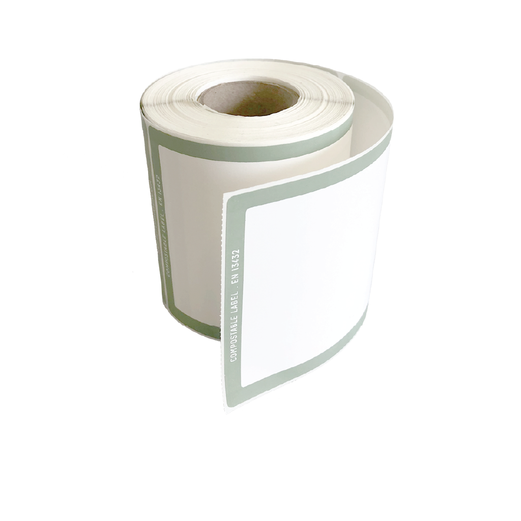 A roll of Better Packaging compostable shipping label with a green border on a transparent background