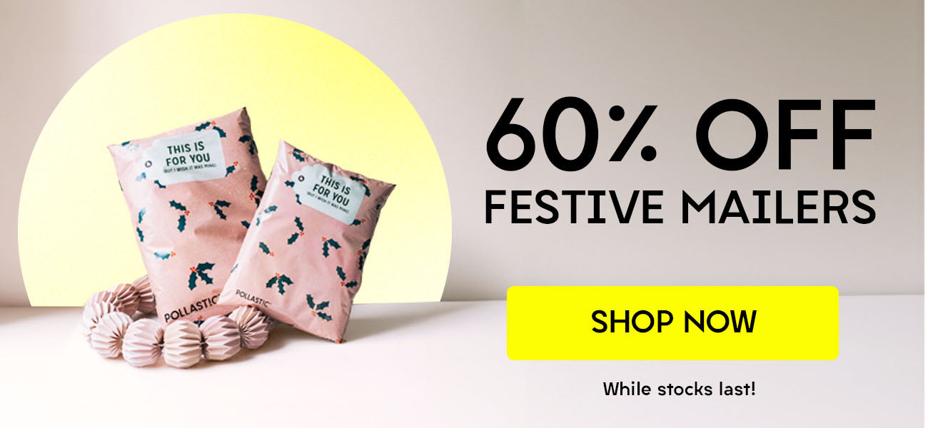Two festive mailers resting on a table - 60% Off Festive Mailers banner 