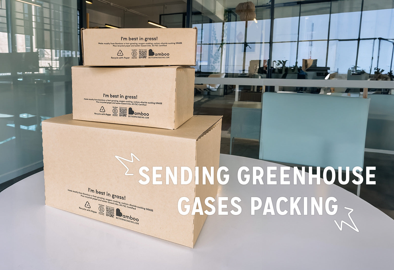 Stacked pile of bamboo boxes with a message "sending greenhouse gases packing", advocating eco-friendly packaging.