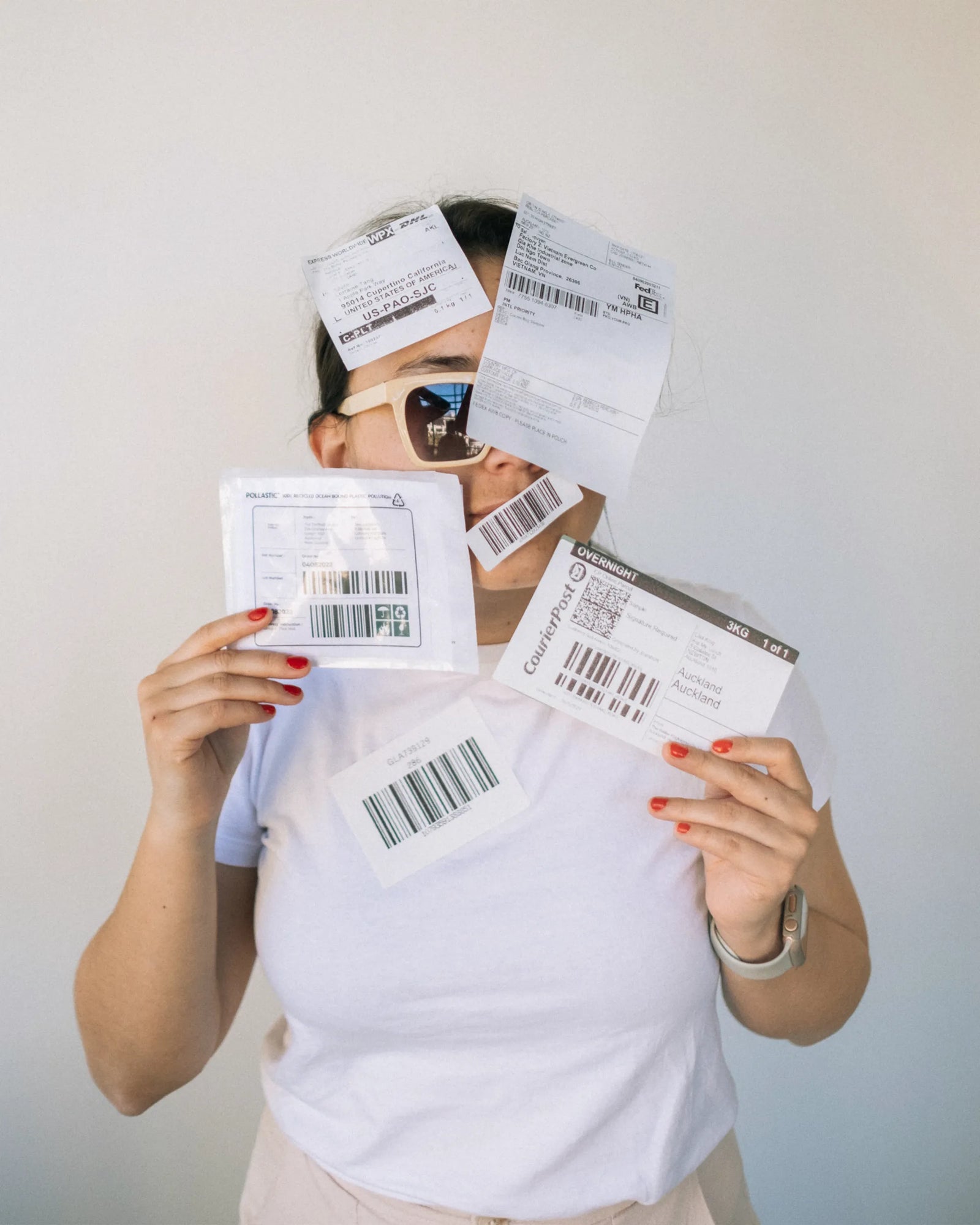 A mixture of compostable and POLLAST!C labels range stuck on a person