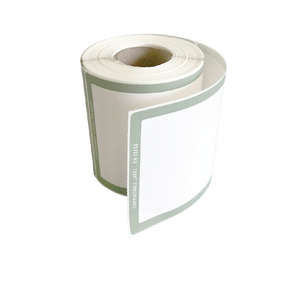 A roll of Better Packaging compostable shipping label with a green border on a transparent background
